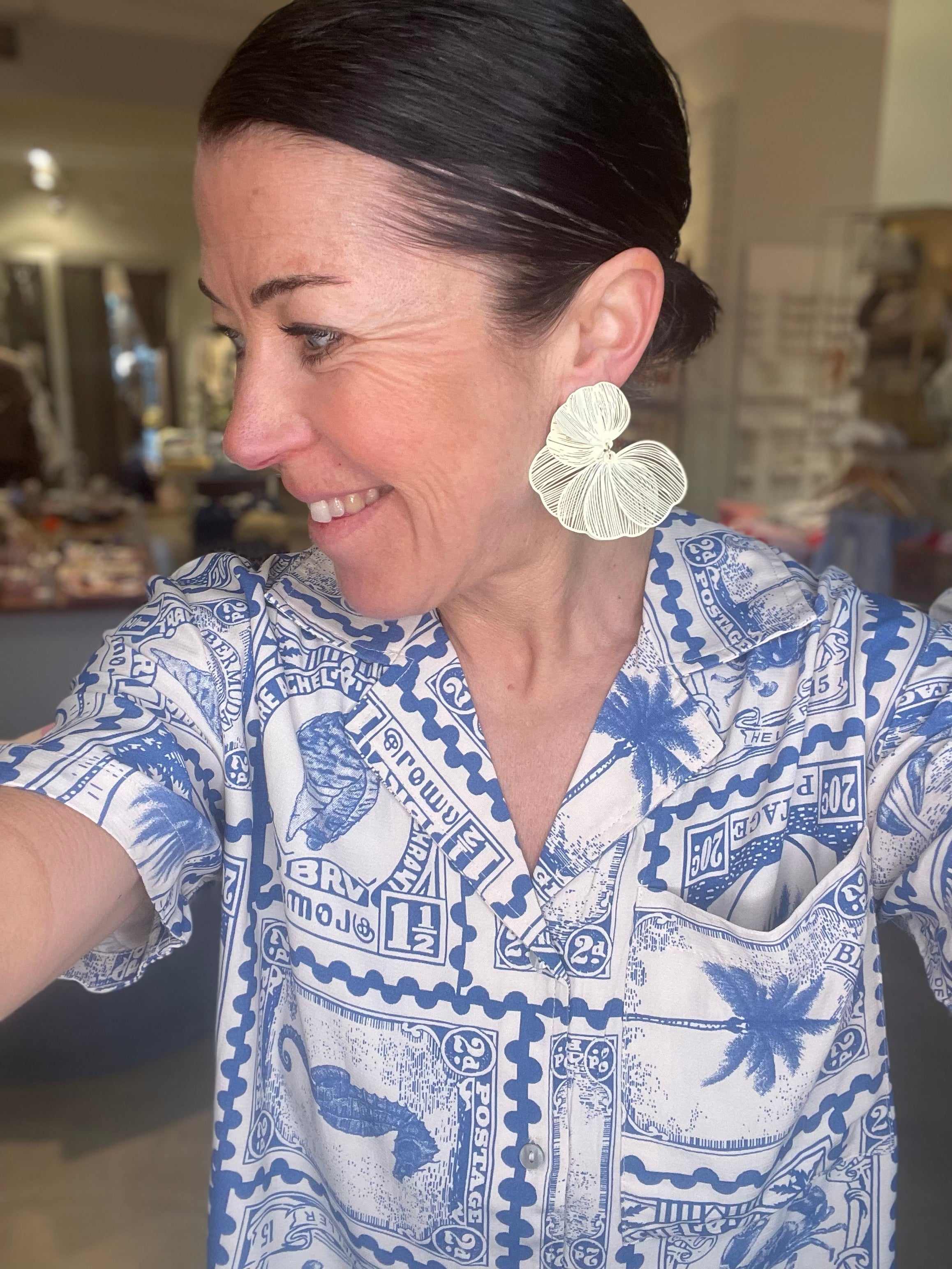 April Earrings Light Dirty Yellow - BECCASIN STORE - Light dirty yellow fabric örhänge with layered fan design, worn with blue patterned smycke shirt.